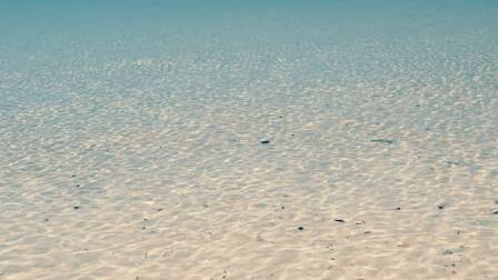 How is beach sand created?